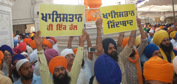 Sikh sangat holding placards with Khalistan slogans